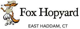 Logo of Fox Hopyard Golf Club with eagle illustration and location details.