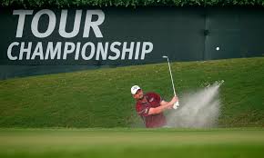 Golfer hitting a sand shot during a championship event.